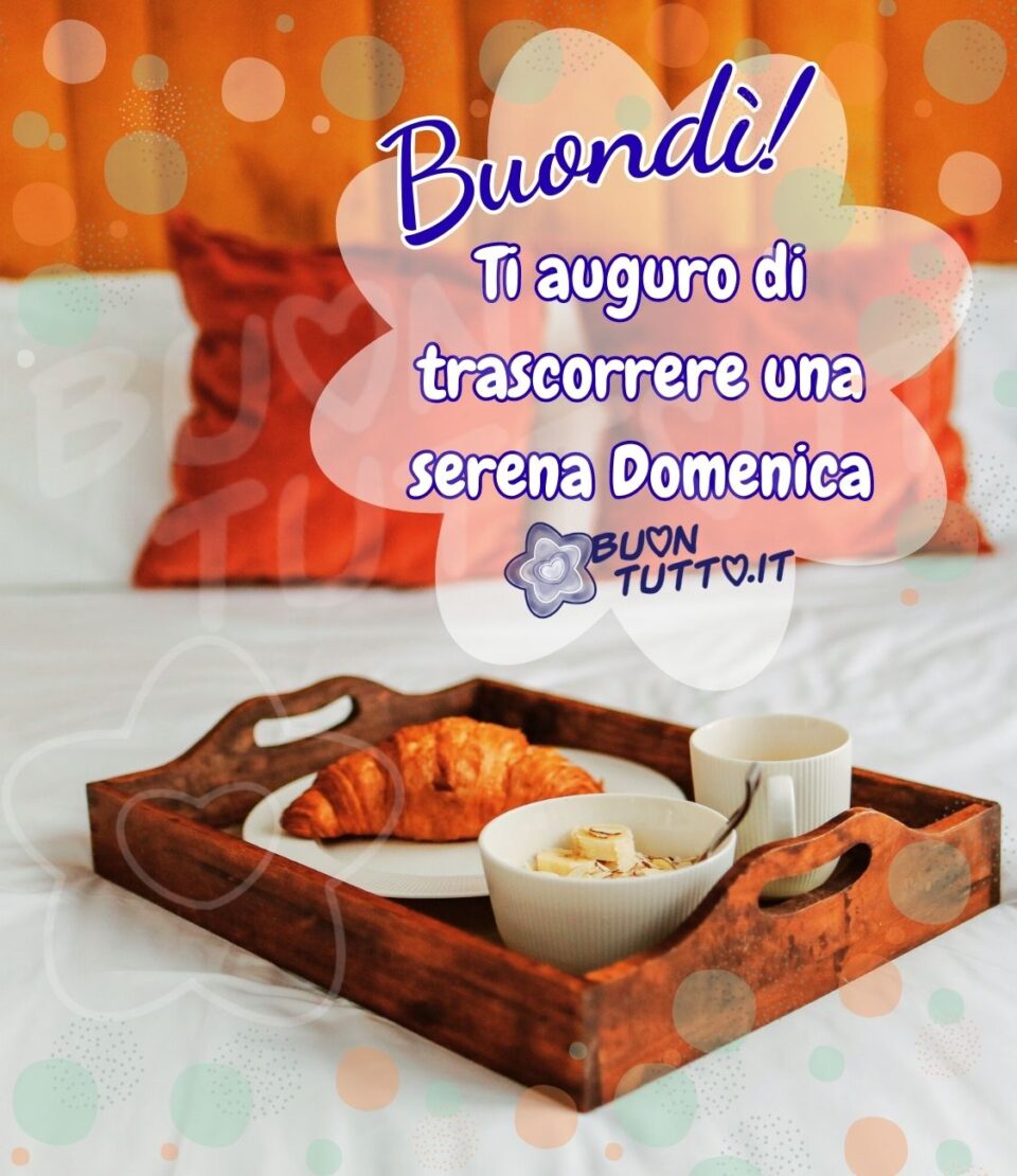 immagine-buongiorno-vassoio-con-deliziosa-colazione-ti-auguro-di-trascorrere-una-serena-domenica-bondì-buontutto foto di un primo piano di un'invitante colazione in un vassoio di legno con dentro un cornetto, una ciotola con del porridge alla frutta e una tazzina di caffè di ceramica bianca, il vassoio è poggiato su un letto con sopra dei cuscini di colore arancione e lo sfondo di colore arancione brillante. Nell'immagine c'è inserito un effetto di luci colorate che crea un'atmosfera sognante e in una nuvoletta a forma di fiore di colore bianco satinato c'è scritto Buondì! di colore azzurro con contorni bianchi e poi di colore bianco brillante con contorni azzurri c'è scritto Ti auguro di trascorrere una serena domenica! da scaricare gratis e condividere con amici parenti gruppi tramite WhatsApp Facebook Twitter Pinterest Telegram Instagram autore buontutto.it