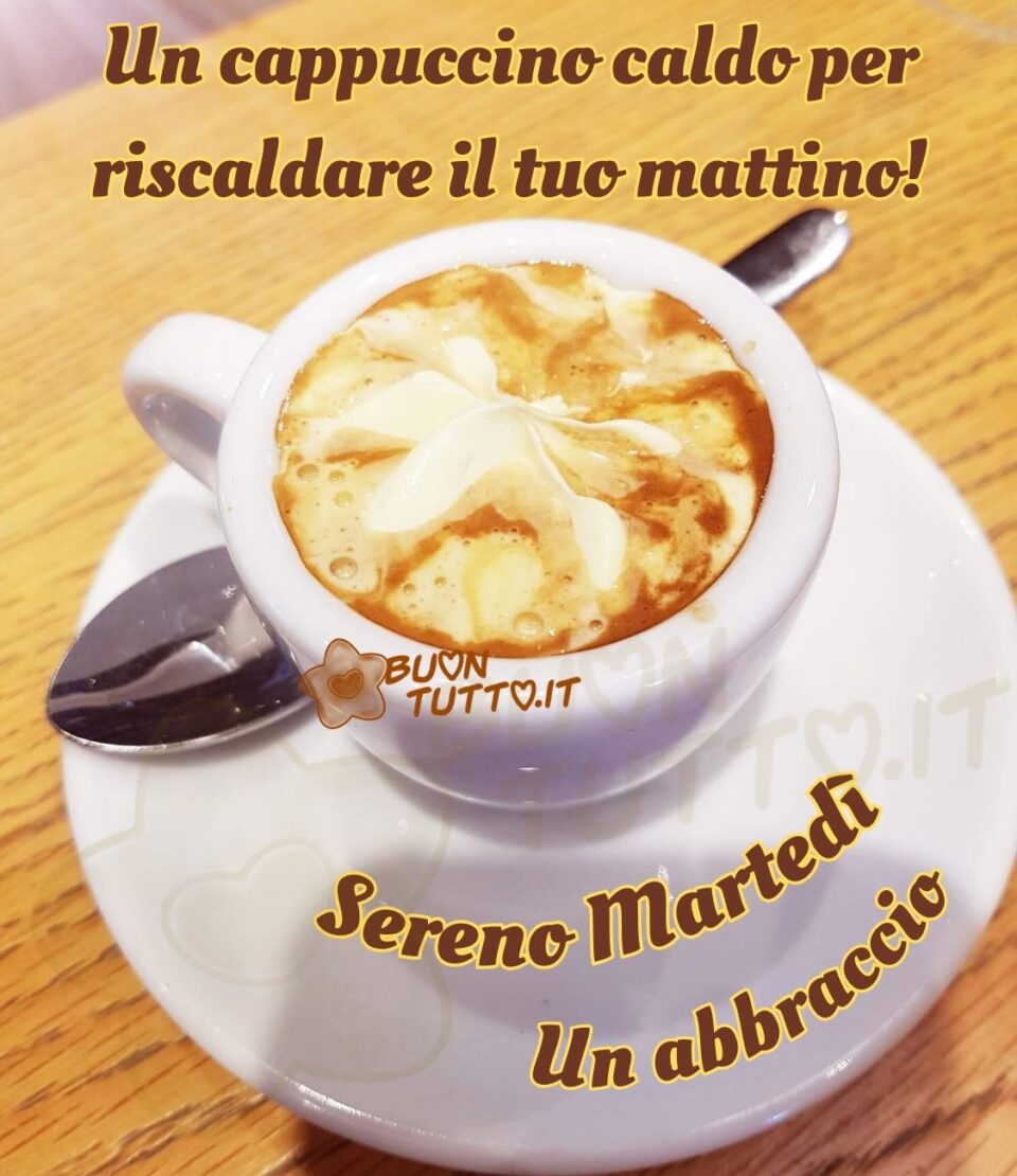 Foto in primo piano di un goloso cappucino decorato con un ciuffo di panna in una tazza di ceramica bianca con piattino. Nella parte alta dell'immagine c'è scritto di colore marroncino con contorno giallo Un cappuccino caldo per riscaldare il tuo mattino!; sopra il piattino in forma semi-circolare dello stesso colore Sereno martedì Un abbraccio. Un'immagine che tramette affetto e calore da scaricare gratis e condividere con amici parenti gruppi tramite WhatsApp, Facebook, X Twitter, Pinterest, Telegram, LinkedIn, Instagram e su tutte le tue piattaforme social preferite creata da buontutto.it