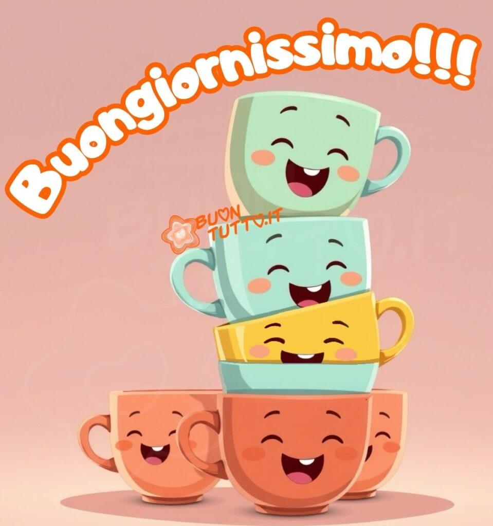 Un'illustrazione di una pila di cinque tazze colorate e due in primo piano con facce di cartoni animati sorridenti e allegre. La tazza superiore è verde chiaro, la seconda è color verde acqua-azzurro, la terza è gialla, la quarta è di colore azzurro-verde acqua, la quinta e le altre due pesca-arancio. Lo sfondo è di un rosa chiaro-malva tenue e uniforme. Nella parte alta dell'immagine c'è scritto in forma semi-circolare in un carattere corsivo grassetto di colore bianco e contorno arancione Buongiornissimo. L'atmosfera generale è luminosa, amichevole e gioiosa. L'immagine trasmette gioia, allegria, festa, amicizia, spensieratezza, serenità, leggerezza, positività, libertà e buonumore da scaricare gratis e condividere con amici, cari, familiari, parenti gruppi tramite WhatsApp, Facebook, X Twitter, Pinterest, Telegram, LinkedIn, Instagram e le tue piattaforme social preferite. Autore BuonTutto.it